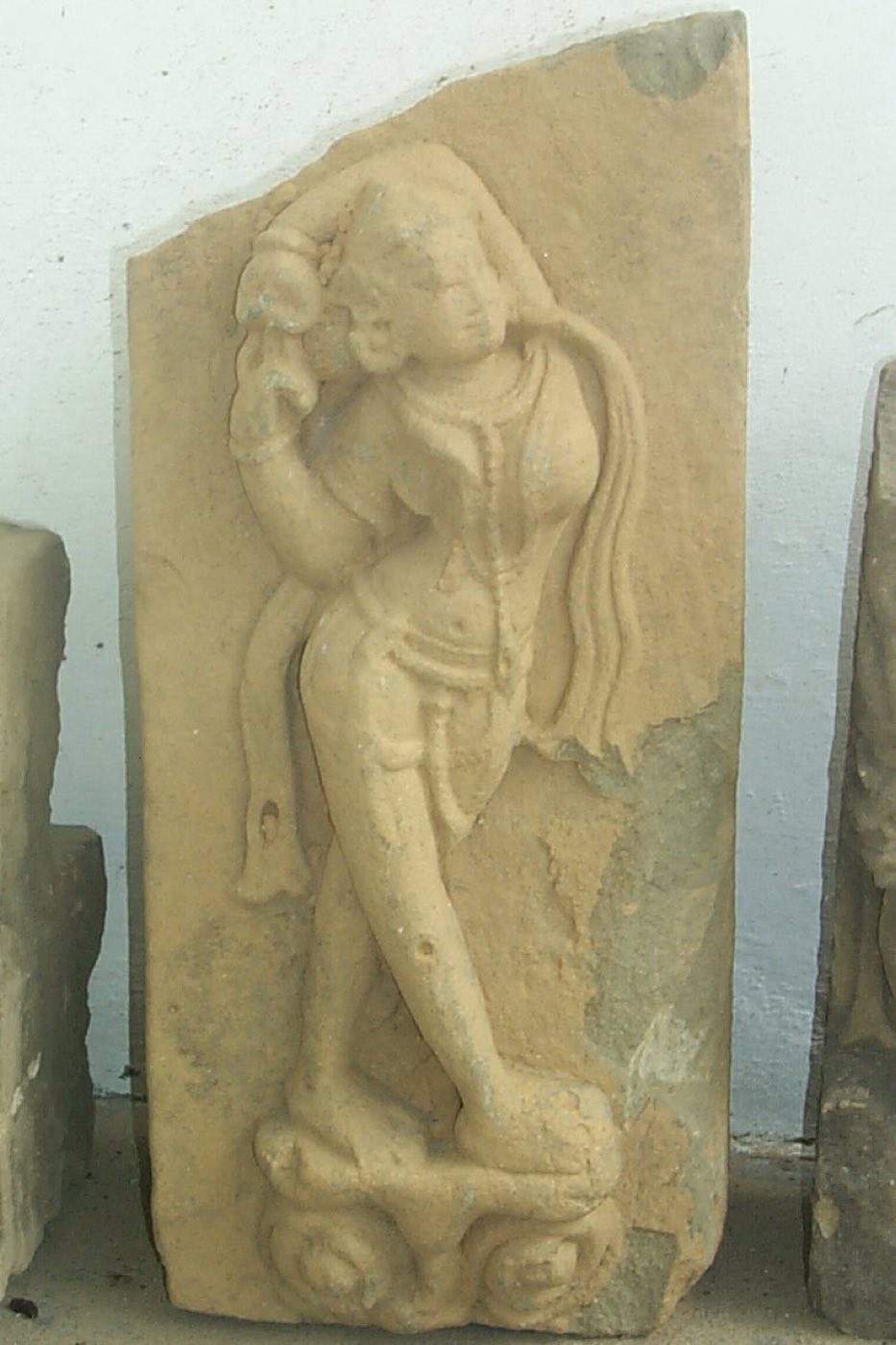 Sculpture fragment of a yakshi from the temple ruins